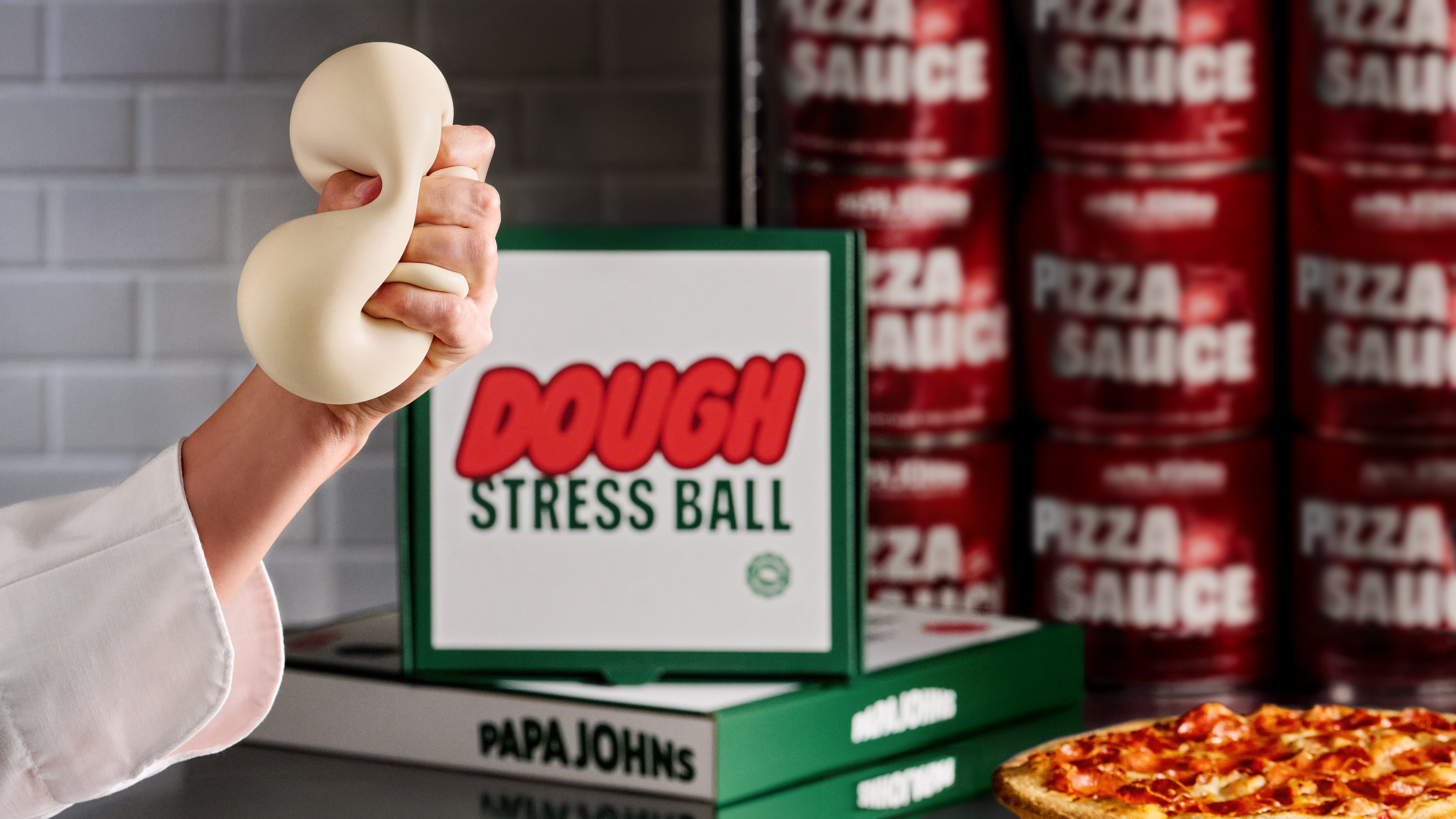 A hand squishing a dough stress ball