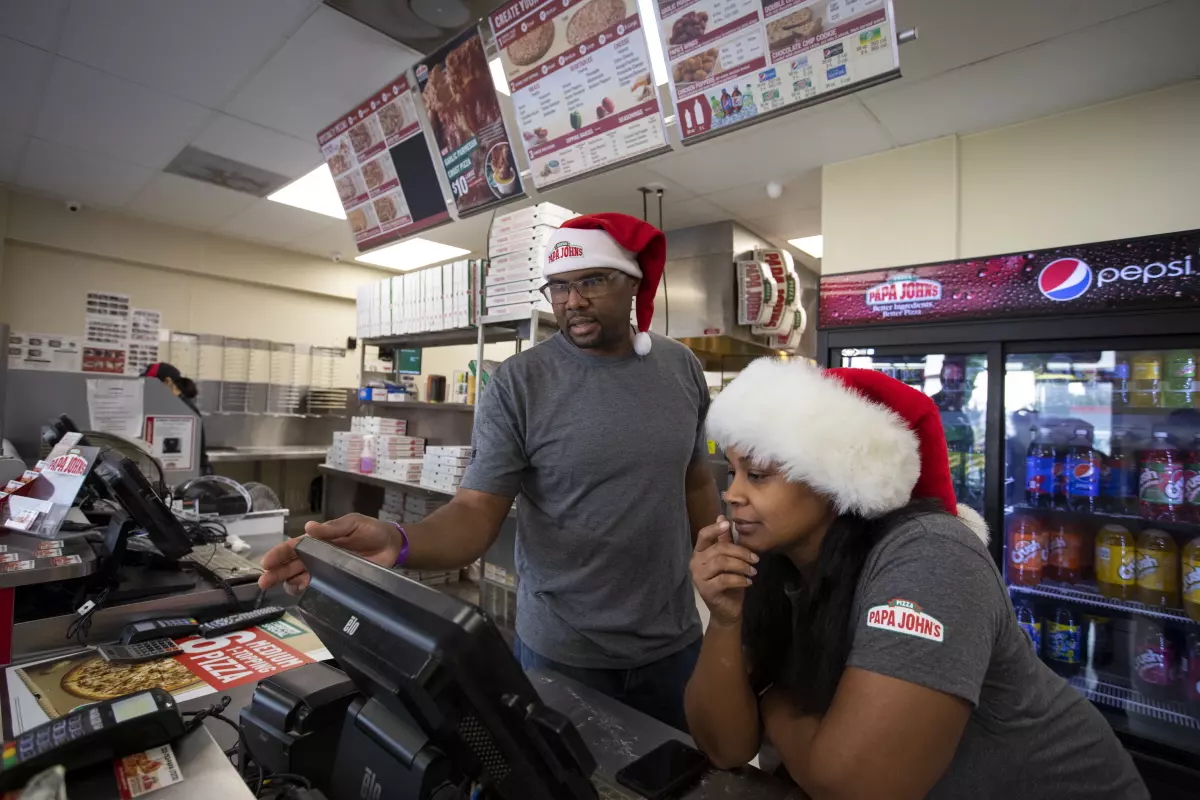 Jarvis and Josslyn Young working in their Papa Johns restaurant