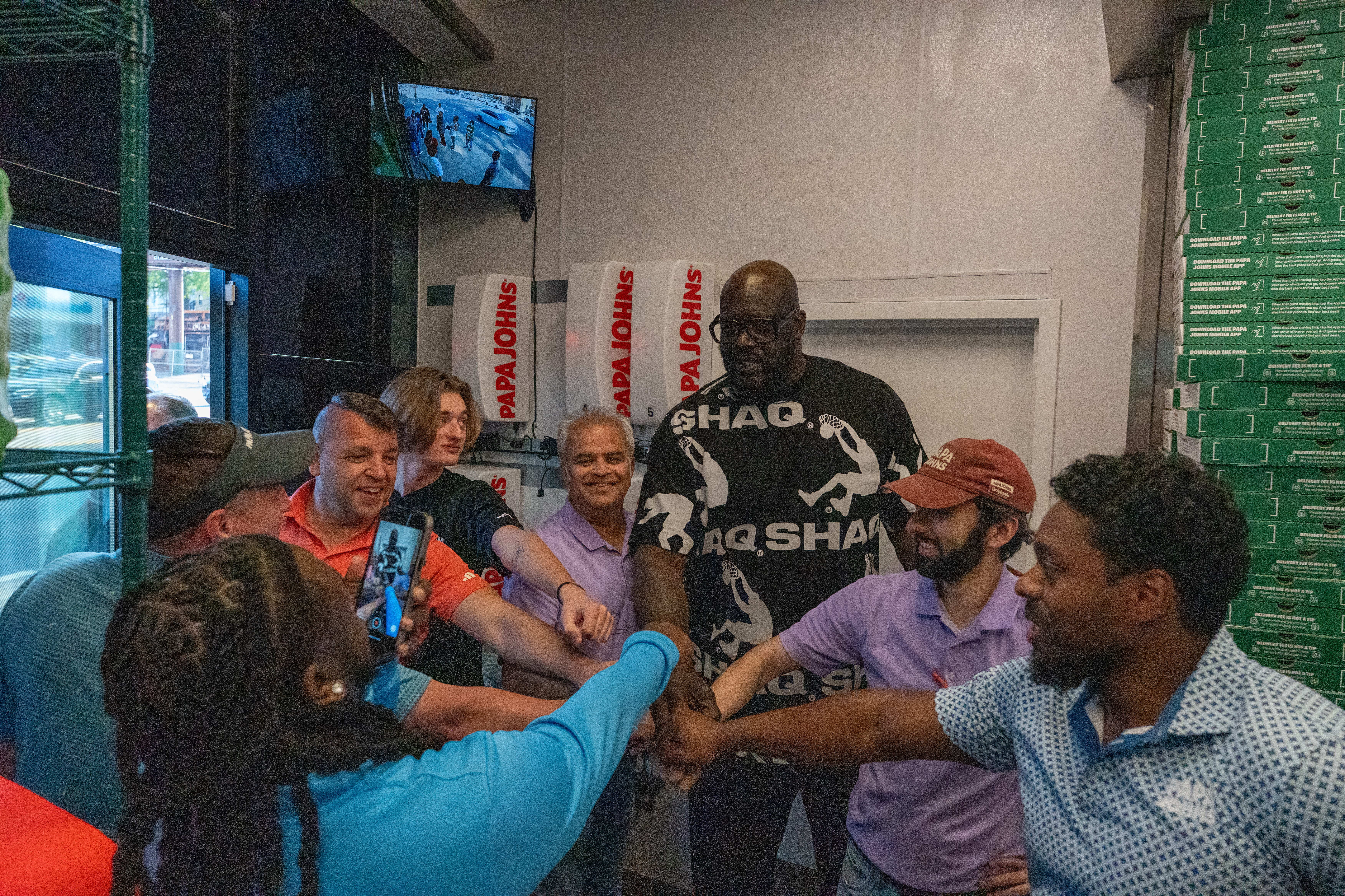 Shaq meets with team members at Papa Johns restaurant