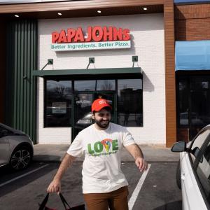 Driver exiting Papa Johns restaurant
