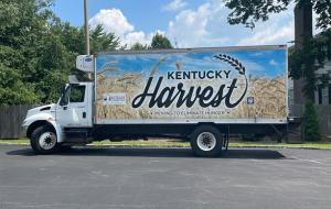 A truck with a sign that reads "Kentucky Harvest" 