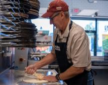 Todd Penegor prepares a pizza at a Papa Johns restaurant